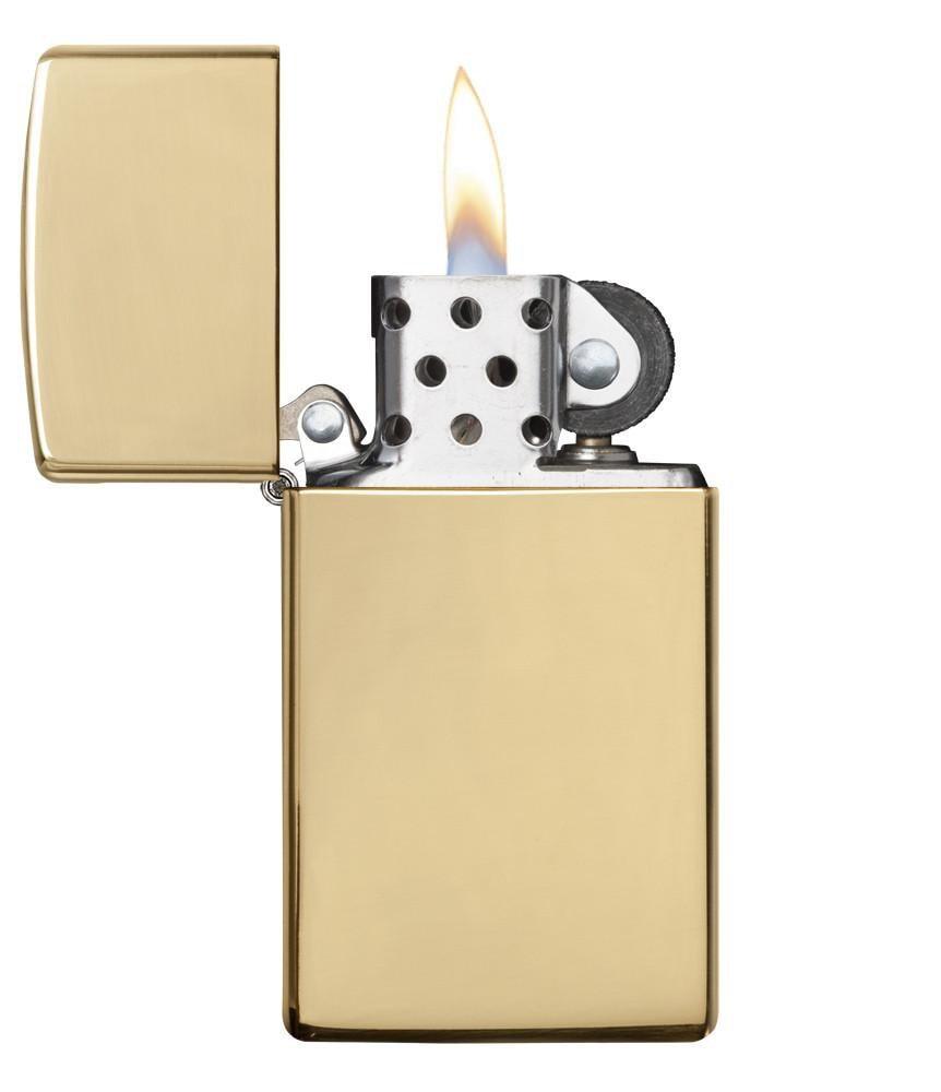 Slim® High Polish Brass Finish Windproof Lighter with its lid open and lit