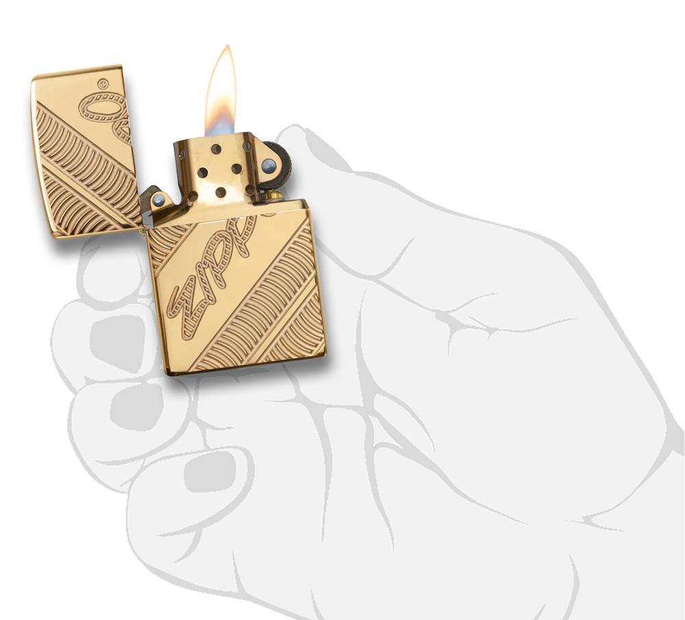 29625 Zippo Coiled Deep Carve Engraving on a High Polish Brass Lighter - In Hand, Open Lit