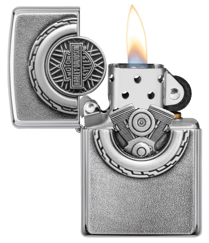 Harley-Davidson® Engine Surprise Emblem Street Chrome Lighter with its lid open and lit