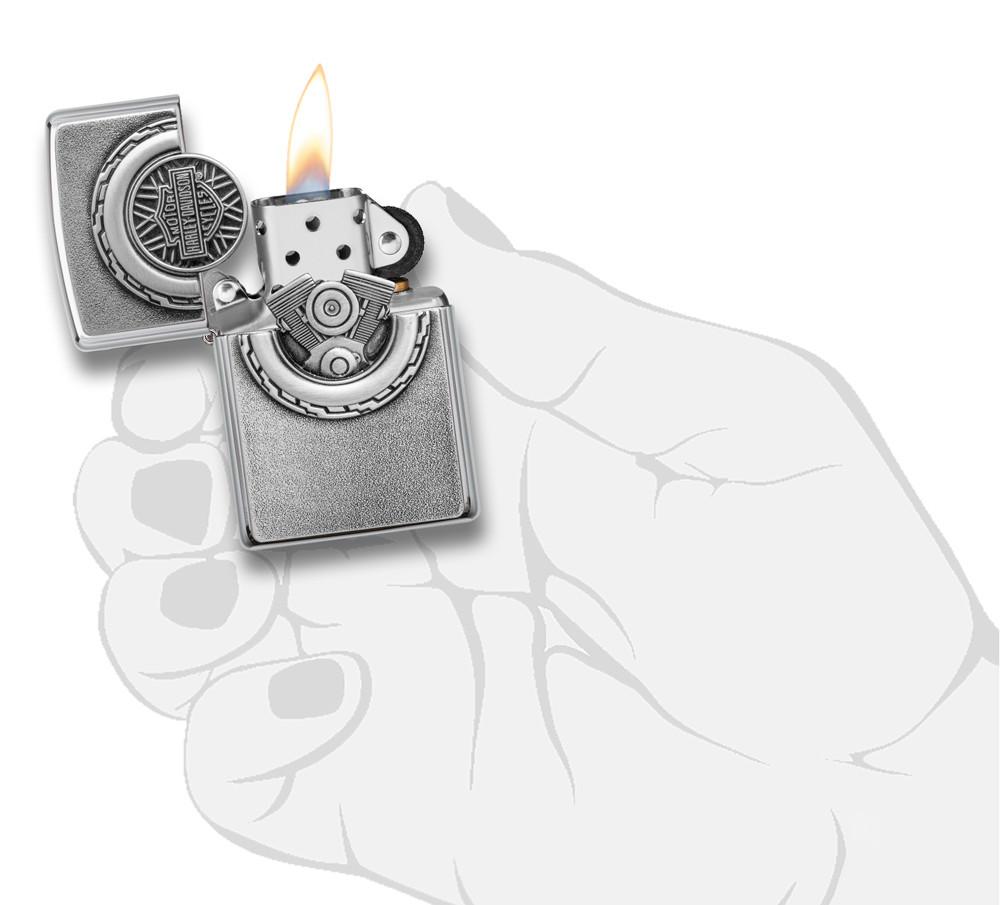 Harley-Davidson® Engine Surprise Emblem Street Chrome Lighter lit in hand