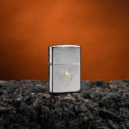 Lifestyle image of Harley-Davidson® Eagles Logo Chrome Arch Windproof Lighter standing on asphalt with an orange background