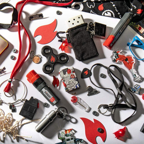 Lifestyle image of Zippo I Spy 540 Color Windproof Lighter, laying within a handful of Zippo themed items.