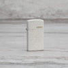 Lifestyle image of Slim® Mercury Glass Zippo Logo Windproof Lighter standing on a marble surface